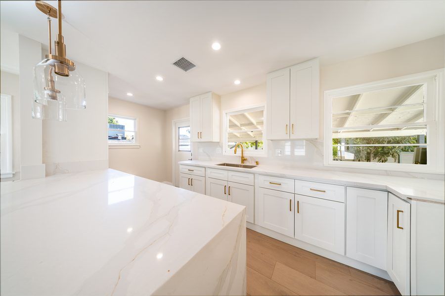 Modern kitchen with white cabinets and pendant lighting - Nazerian Builders Los Angeles