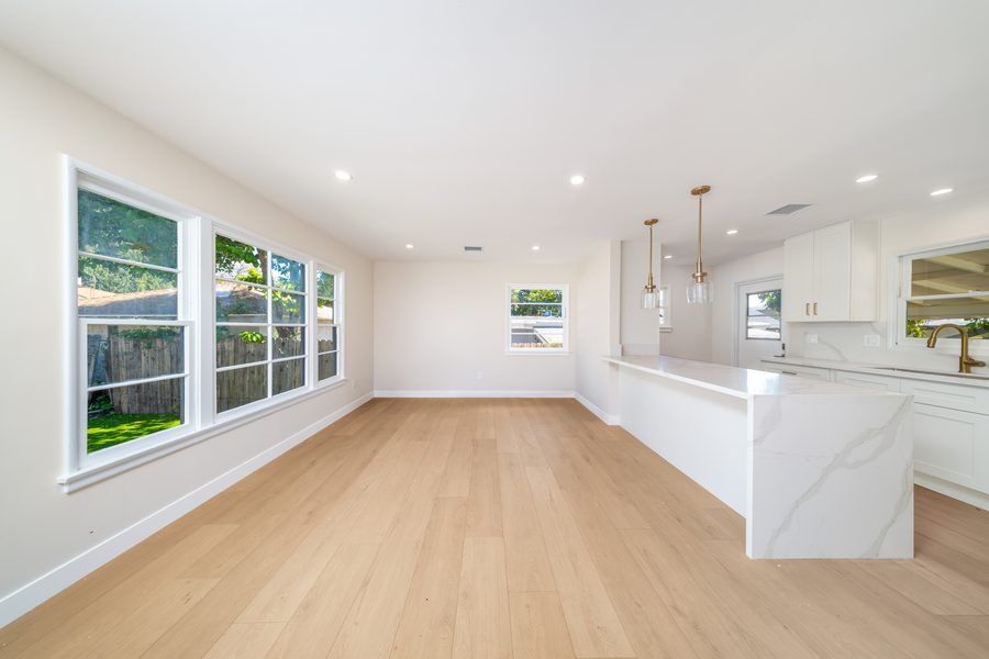 Open living area with natural light and hardwood floors - Nazerian Builders