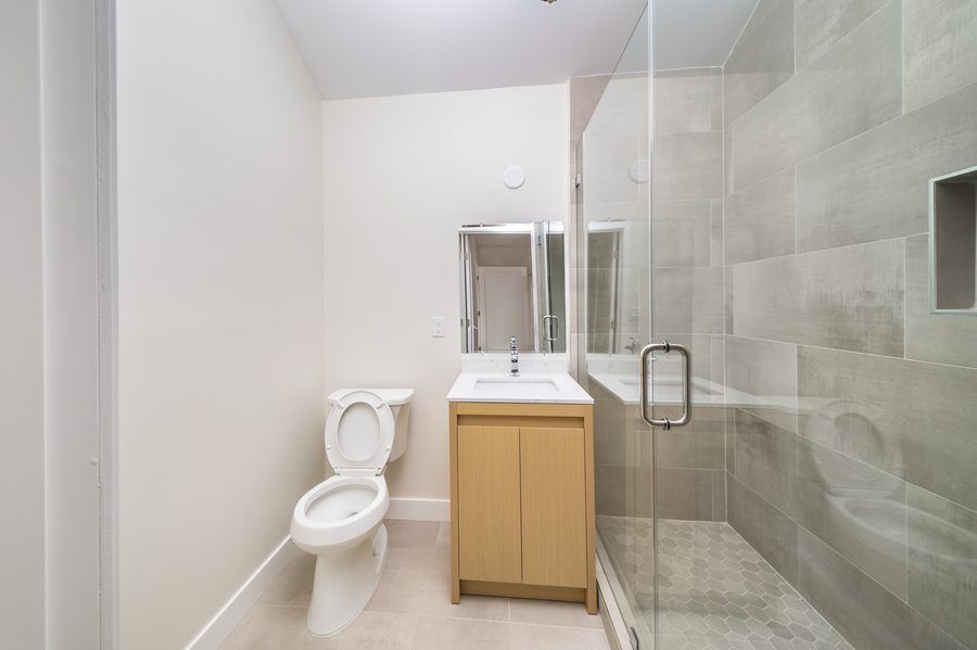 Modern bathroom with glass shower and tile work - Nazerian Builders Los Angeles